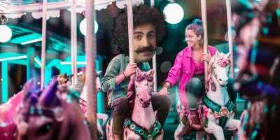 Man on merry-go-round with love interest